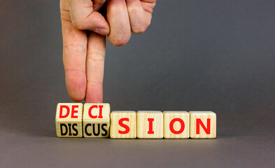 Fototapeta premium Discussion and decision symbol. Concept word Discussion and Decision on wooden cubes. Businessman hand. Beautiful grey table grey background. Business discussion and decision concept. Copy space.