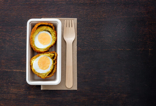 Dutch deep fried snack from Province Groningen called Eierbal on the table, hard-boiled egg with ragout and breadcrumbs