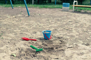 Sandbox with children's bucket, shovel and rake