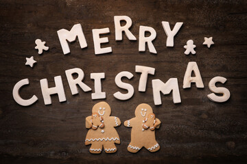Merry Christmas With Cookie Letters on Wooden Background WithGingerbread People - 551593923