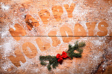 Background With Happy Holidays Written With Cookie Dough Letters and Powdered Sugar