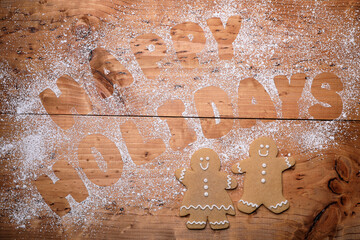 Background With Happy Holidays Written With Cookie Dough Letters and Powdered Sugar