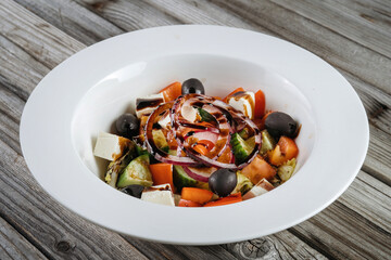 Greek salad with fresh vegetables, feta cheese and black olives.