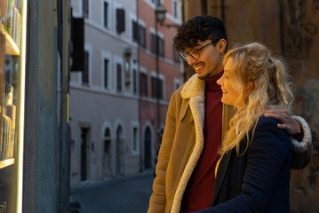 Fototapeta premium Multiethnic couple looking at a shop window
