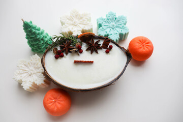 original christmas candle in coconut and fir branches