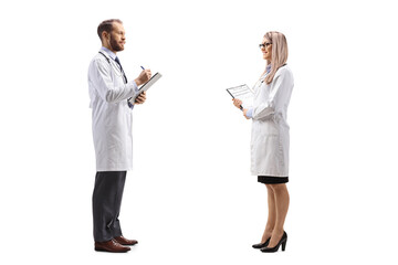 Doctor talking to a female colleague and writing a document