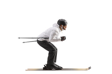 Full length profile shot of a male skier skiing