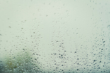 Drops on glass after rain. Autumn weather outside window. Rain outside window.