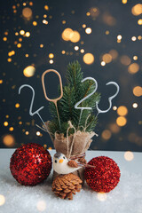 New Year, Christmas background. Candle numbers 2023 in silver and gold with a decorative small...