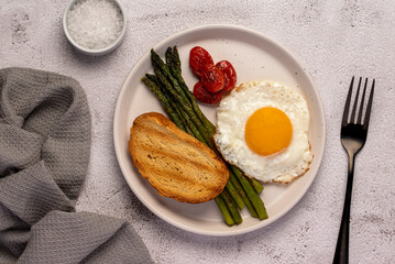 Food photography of fried egg, tomato, asparagus, toast,  salt, breakfast