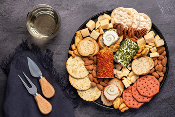 Food photography of antipasti, cheese, cheddar, parmesan, toast, cracker, almond, pecan, wine