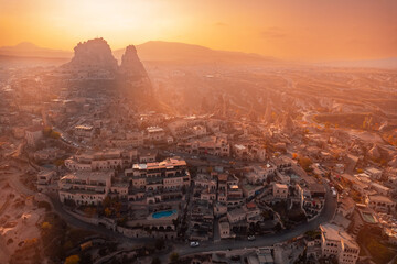 Ancient town of Uchisar castle at sunset, Cappadocia Turkey. Aerial top view from drone Nevsehir Province