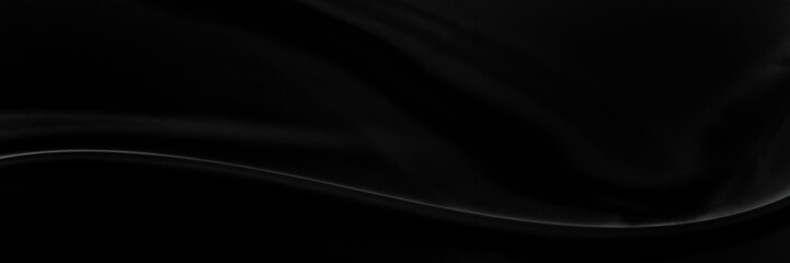 Black gray satin dark fabric texture luxurious shiny that is abstract silk cloth background with patterns soft waves blur beautiful.