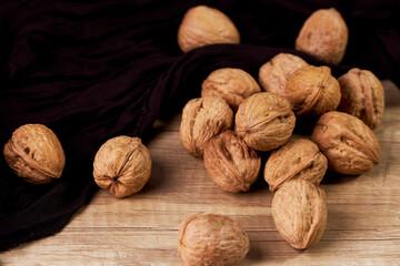 Close-up of tasty in-shell walnuts on wooden table