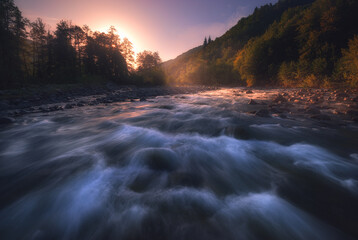 sunrise over fast mountain river