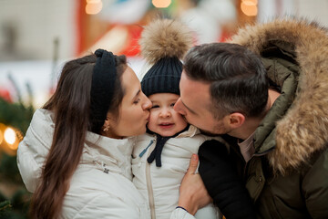 Beautiful happy family at the Christmas market. Winter holiday. Holidays in Europe. New Year.