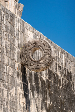 A large stone ring set on a high wall for a traditional Mayan ball game. Archaeological area of the Chichen Itza pyramids in Mexico.