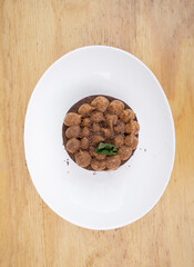 Chocotorta. Top view of a cake made with chocolate biscuits and dulce de leche cream, in a white dish.