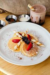 Hot cakes with strawberry, raspberry and chocolate on a plate.Breakfast.