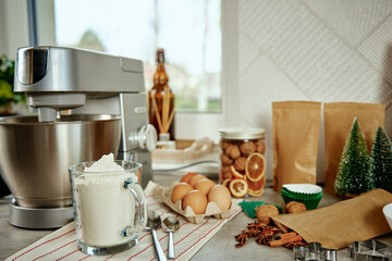 Preparation of dough in an electric mixer at home. Professional mixer for kneading dough and food ingredients in kitchen interior. Modern appliances in the kitchen