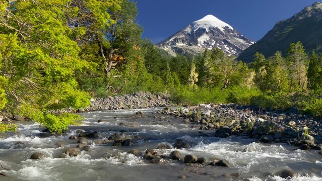 Landscape with volcano, mountain river and green trees. Lanin volcano in Lanin national park. Argentina, Patagonia, Lake district