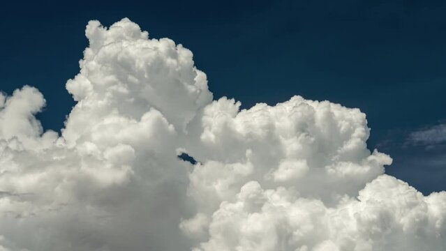 Big white fluffy clouds time lapse. White clouds and blue sky. UHD 4K