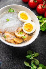 asian soup rice noodles funchose, egg, mushrooms Pho Bo meal food snack on the table copy space food background rustic top view