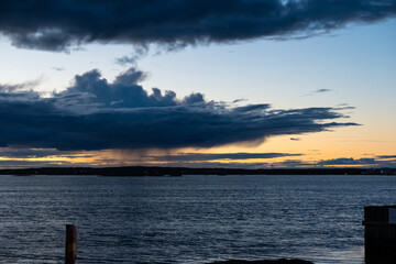 Clouds at golden sunset with local rain on the horizon.