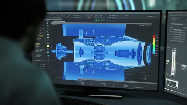 Engineer examining the parts of the industrial turbine in technical software. Engineer using technical software to look inside the 3D turbine model. Technical engineering software displays components.