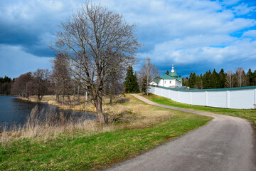 Landscape photo with a road along the Orthodox monastery