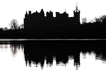 The silhouette of an old castle and its reflection in the lake water. Linlithgow Palace, Scotland