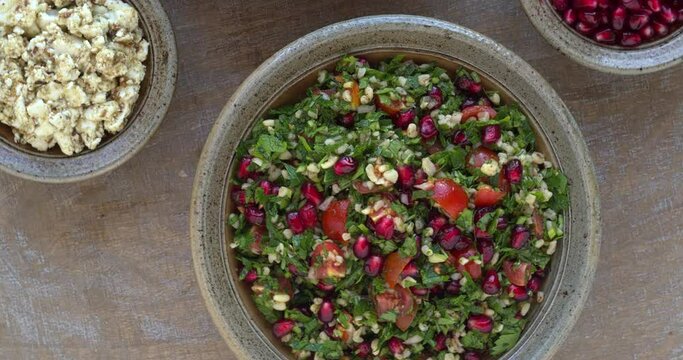 Two parsley salads: tabbouleh like barley and parsley salad with feta and cashew nuts and classic tabbouleh with pomegranate.