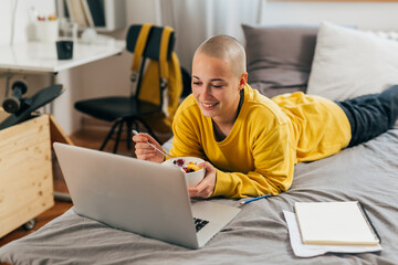 College student listens to online class in her room