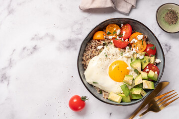 Keto diet plate quinoa, avocado, egg and tomatoes. Healthy food, ketogenic diet