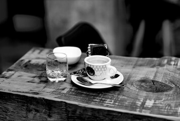 Espresso cup on wooden bistro table black and white