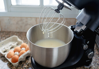 Close up caption of cake mixing inside mixer bowl. Bakery at home concept