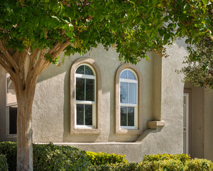 Fototapeta na wymiar windows on stucco wall of a single family residence