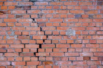 Cracked red brick wall. Brick wall background