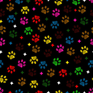 Colorful paw prints with stars seamless fabric design pattern with dark background
