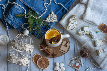 Fototapeta na wymiar Hot tea with orange, sweets and decorations for the new year.