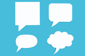 Set of paper speech bubbles on a blue background. Chat flat icons in the form of speech bubbles of various shapes. Free space for text or picture. Signs of speech communication