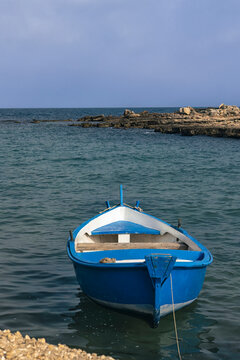 Traditional Wooden Fishing Boat With Blue Hull And White Interior