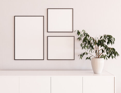 Bright living room interior with empty white pictures in the frame, scandinavian room, wall and dresser with plant.