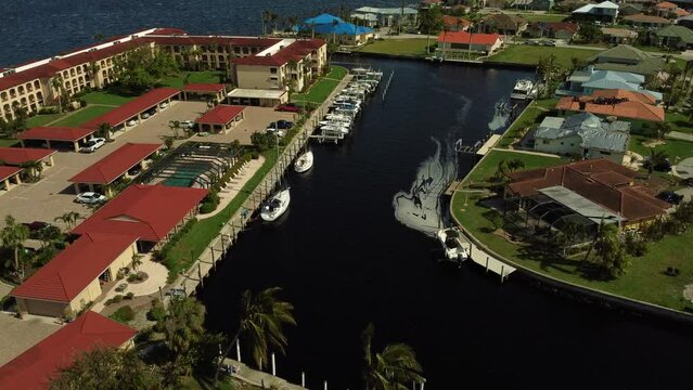 Slow motion aerial shot over a canal with boats in Punta Gorda, Florida.