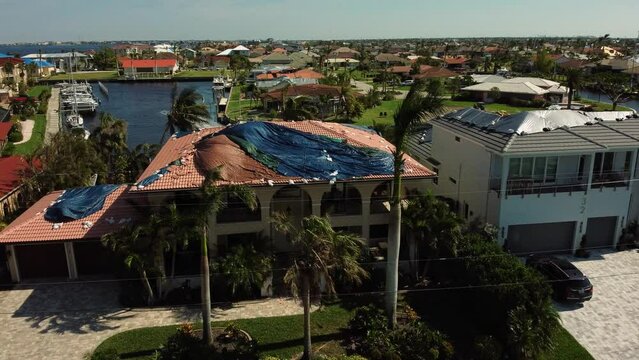 Aerial view of roof tarps over buildings after hurricane Ian in Punta Gorda, Florida