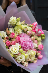Big floral bouquet with roses and hydrangea in woman hands