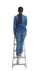 Young woman climbing up metal ladder on white background, back view