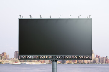 Blank black horizontal billboard on city buildings background, front view. Mockup, advertising concept