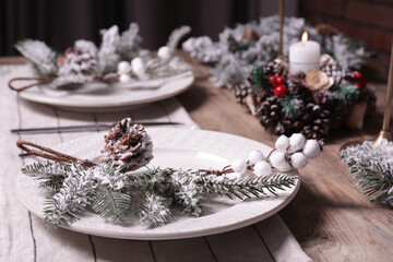 Obraz na płótnie Canvas Plate with cutlery and festive decor on wooden table