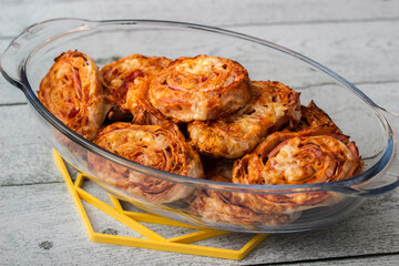 Homemade mini pizza buns topped with tomato sauce, ham and cheese